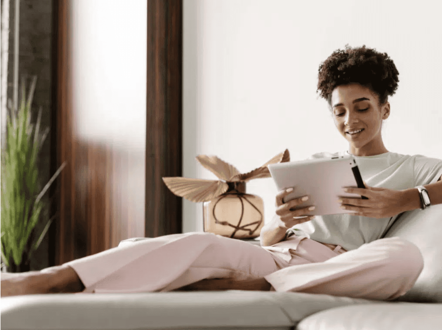 Woman reviewing aesthetic training on tablet, exploring Botox side hustle options.